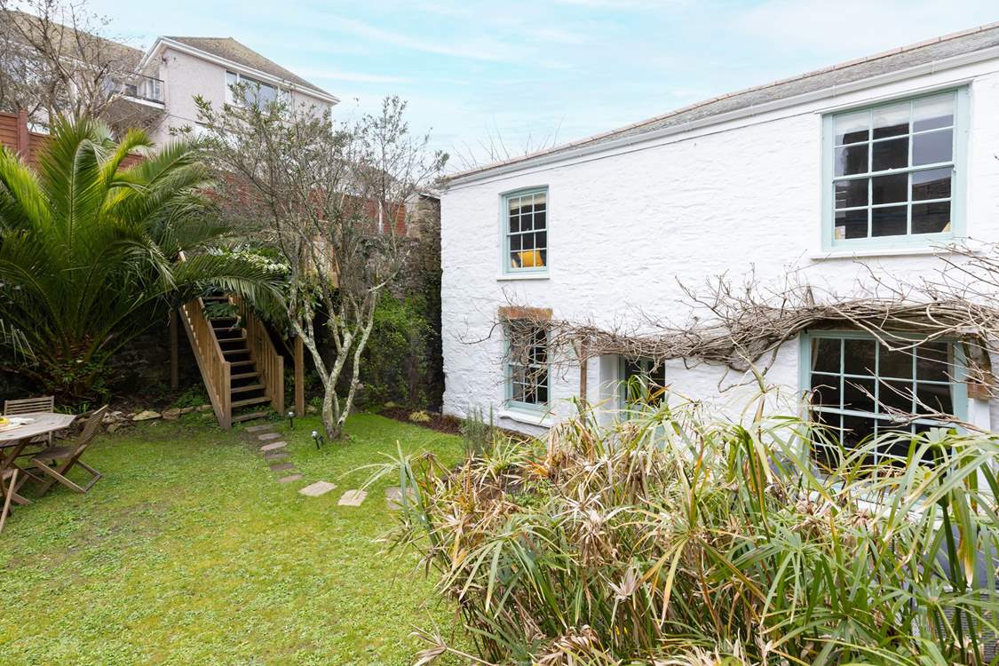 The steps lead up to the hot tub and lovely seating area, please mind the stunning palm tree you have to pop under.