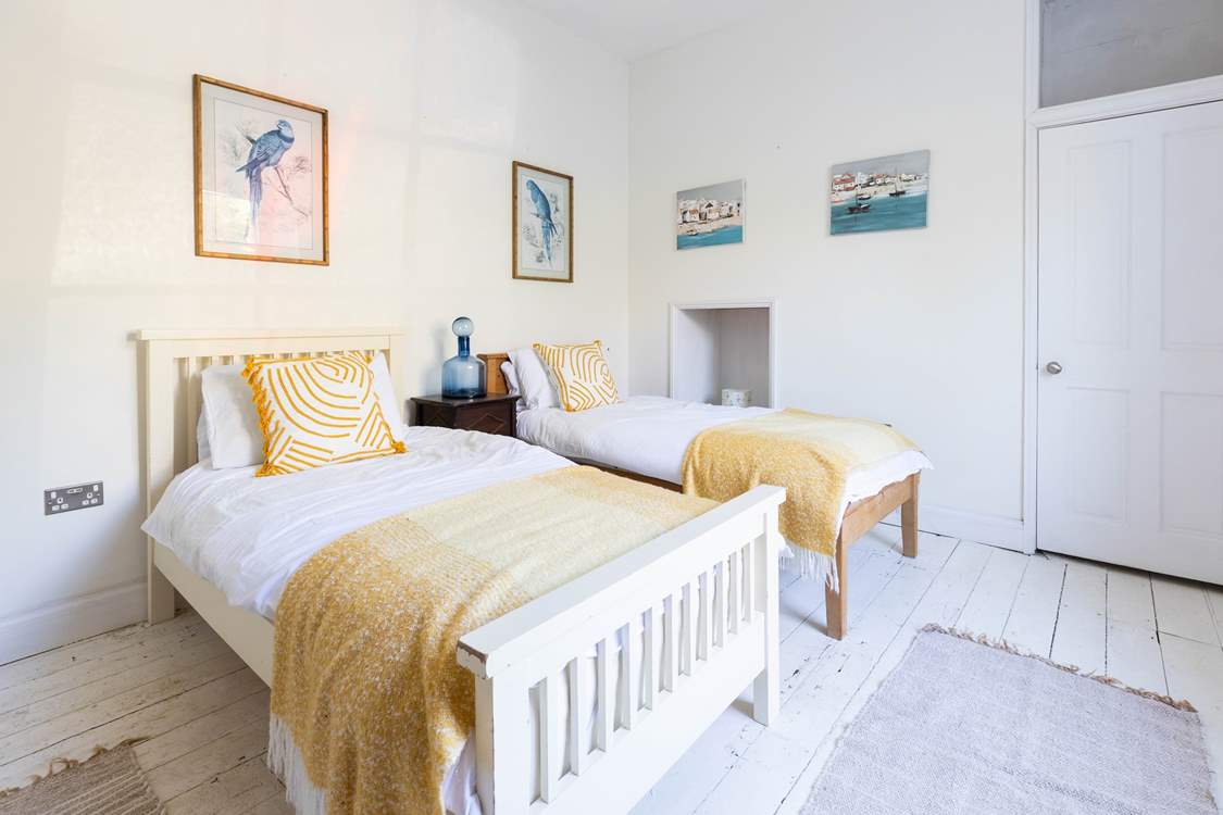 The twin bedroom is a sunny calm space.
