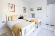The twin bedroom is a sunny calm space.