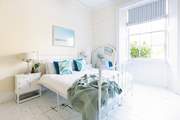 The main bedroom has a king-size bed and a single bed for little ones.