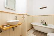 The family bathroom has a fabulous roll-top bath.