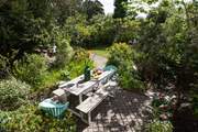 The dining table is in dappled sunlight, perfect for those long relaxing lunches.