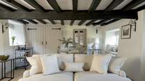 Original beams grace the sitting-room.