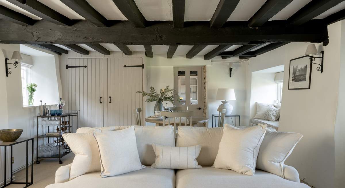 Original beams grace the sitting-room.