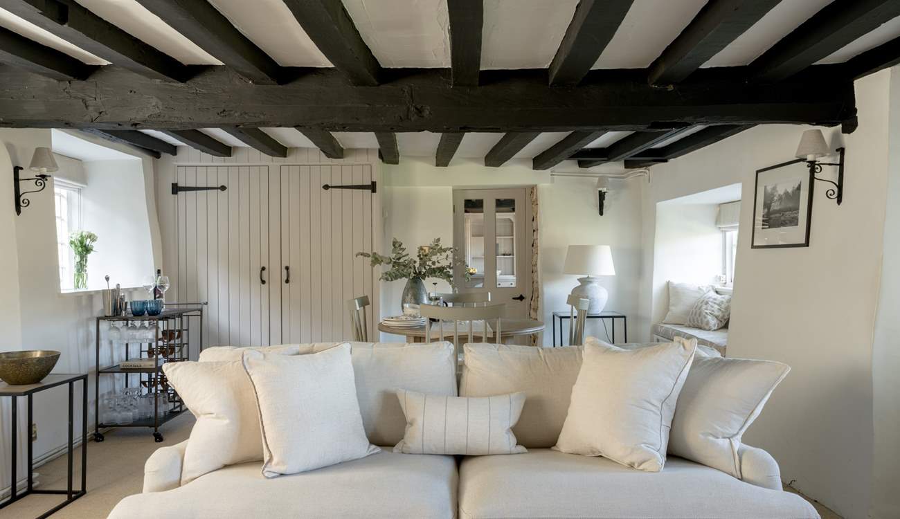 Original beams grace the sitting-room.