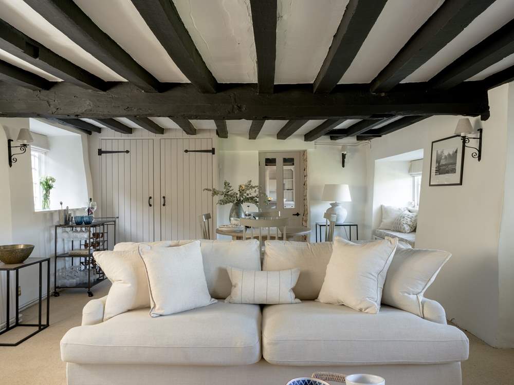 Original beams grace the sitting-room.