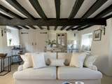 Original beams grace the sitting-room.