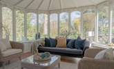 The large conservatory looks out over the very pretty garden. - Thumbnail Image