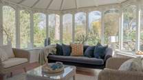 The large conservatory looks out over the very pretty garden.