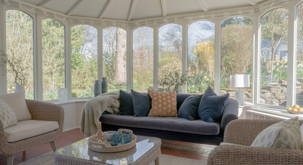 The large conservatory looks out over the very pretty garden.
