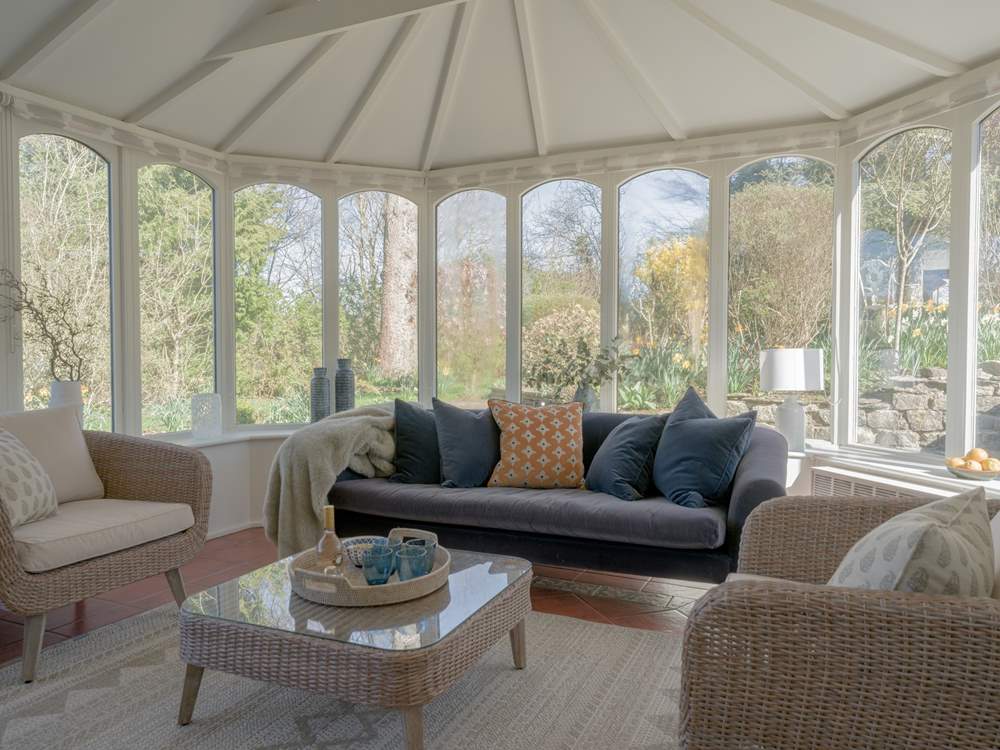 The large conservatory looks out over the very pretty garden.