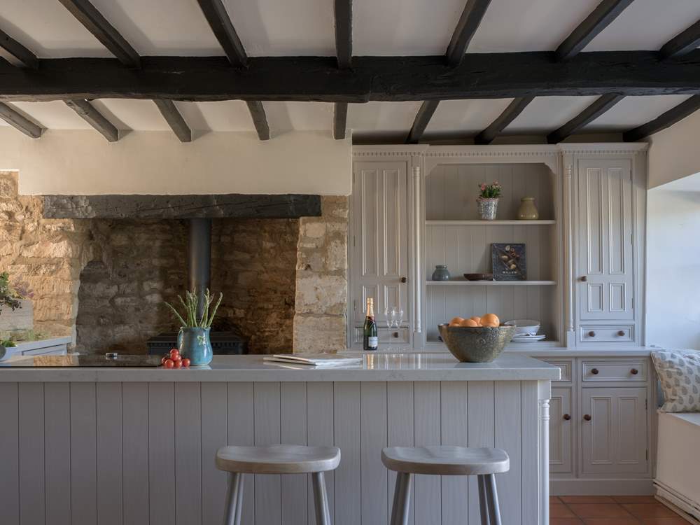 There is an ornamental wood-burner in the kitchen, just look at that inglenook fireplace.