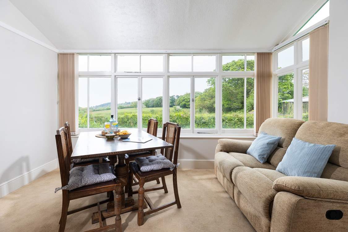 The dining-table in the sitting-room has wonderful views over the countryside.