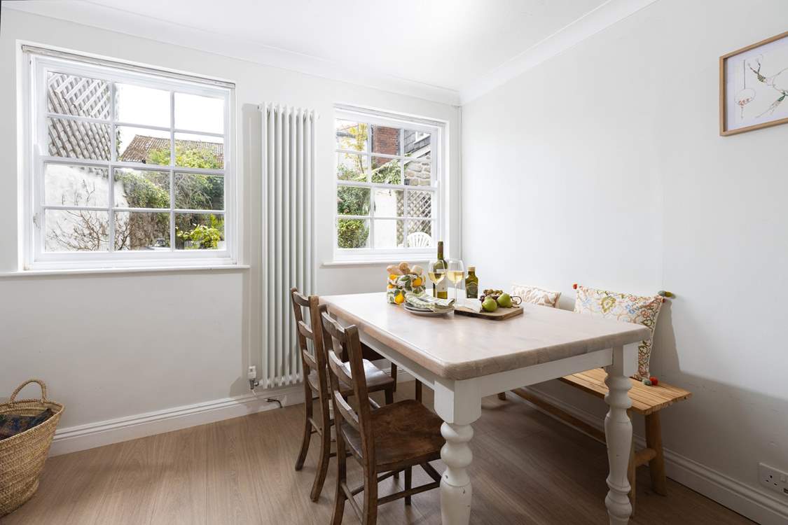 The dining-table looks out over the pretty courtyard garden.