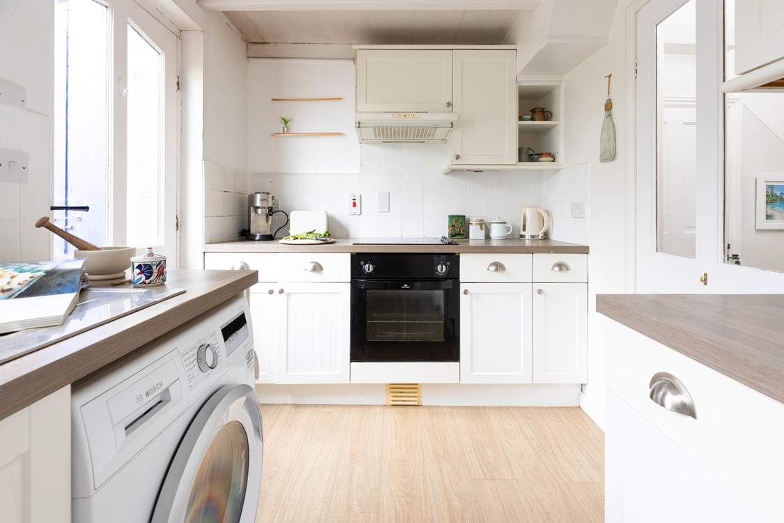 The galley kitchen is well-equipped for all your culinary needs.