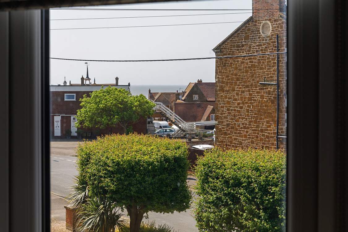 Enjoy sea glimpses from the bay window.