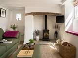 Beams and natural stone walls give a nod to the history of this gorgeous cottage.