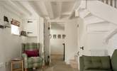 The staircase is narrow and winds to the first floor.  - Thumbnail Image