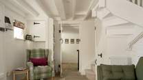The staircase is narrow and winds to the first floor. 