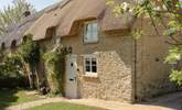 A pie crust roof graces this pretty cottage.  - Thumbnail Image