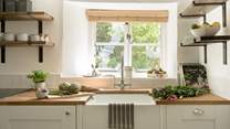 The kitchen window looks out over the front garden and the verdant hedge. 