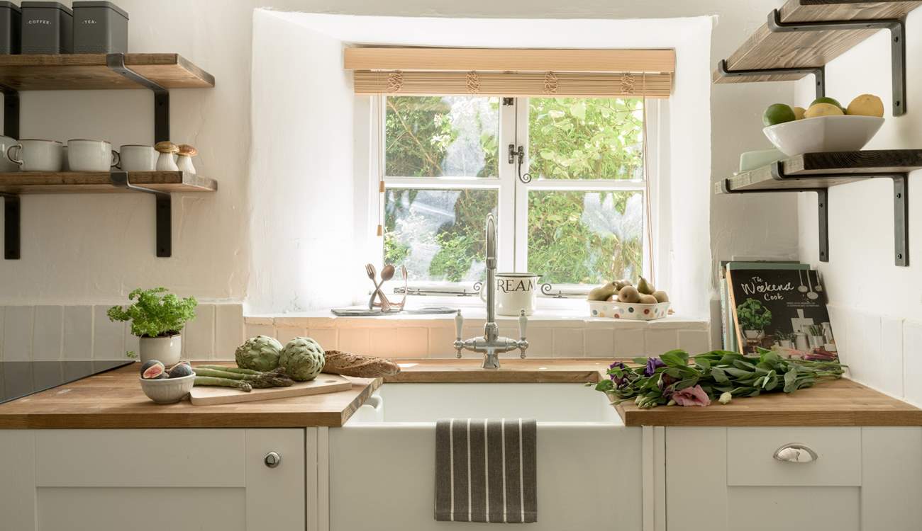 The kitchen window looks out over the front garden and the verdant hedge. 