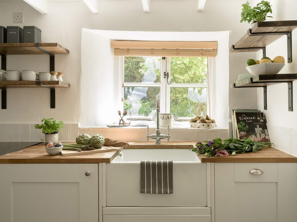 The kitchen window looks out over the front garden and the verdant hedge.