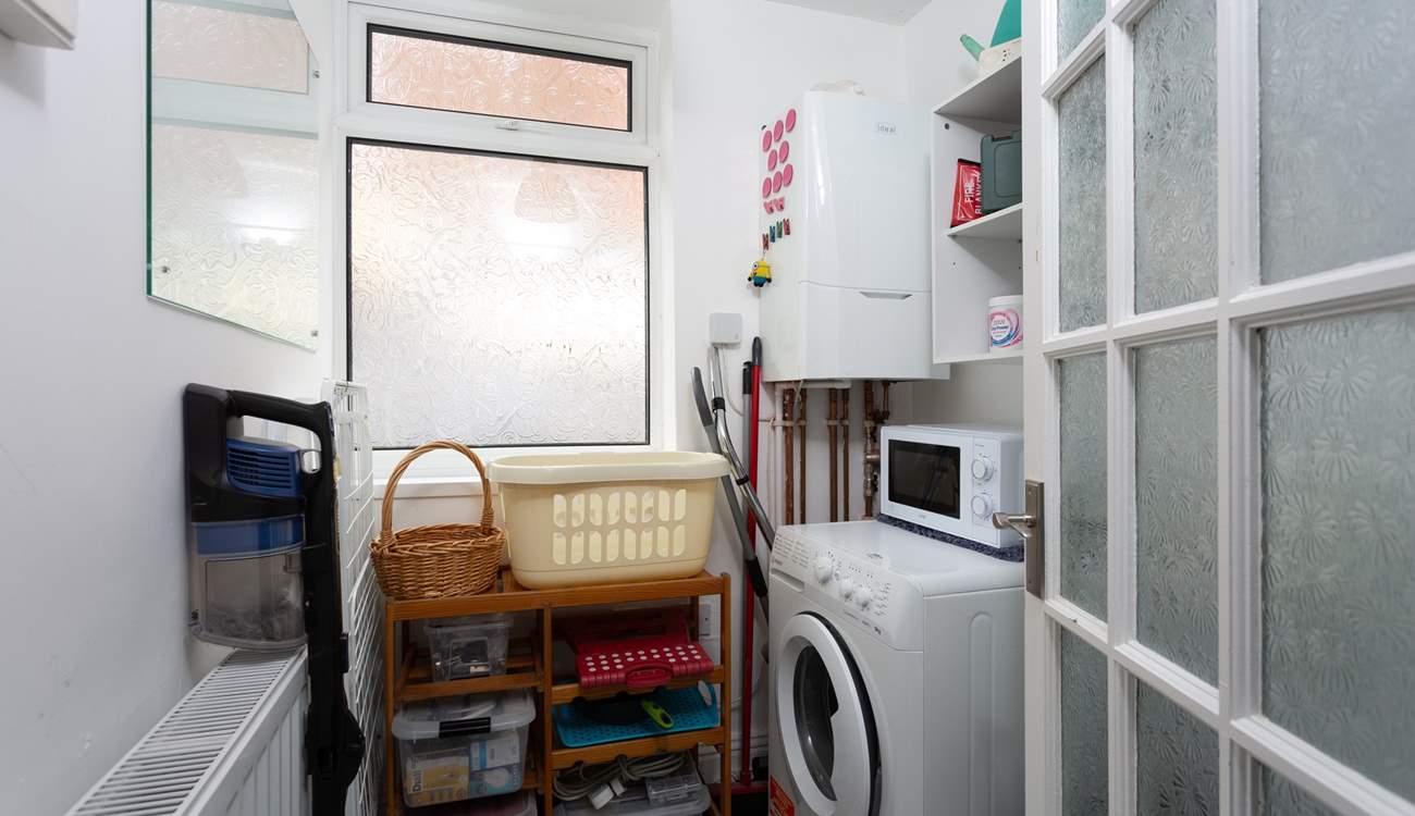 The utility-room has a washing machine.