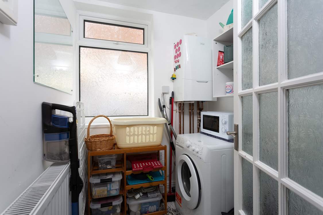 The utility-room has a washing machine.