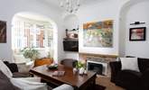 The cosy sitting-room has plenty of seating for everyone. - Thumbnail Image