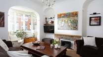 The cosy sitting-room has plenty of seating for everyone.