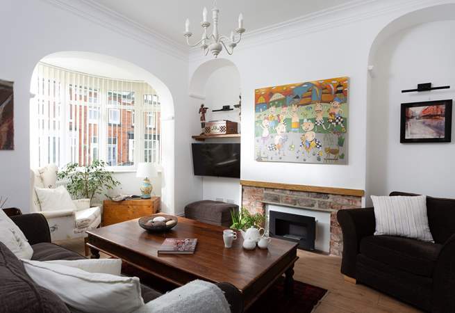 The cosy sitting-room has plenty of seating for everyone.
