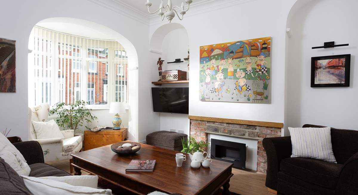 The cosy sitting-room has plenty of seating for everyone.