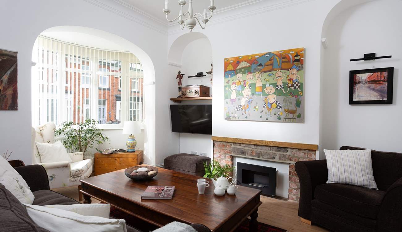 The cosy sitting-room has plenty of seating for everyone.