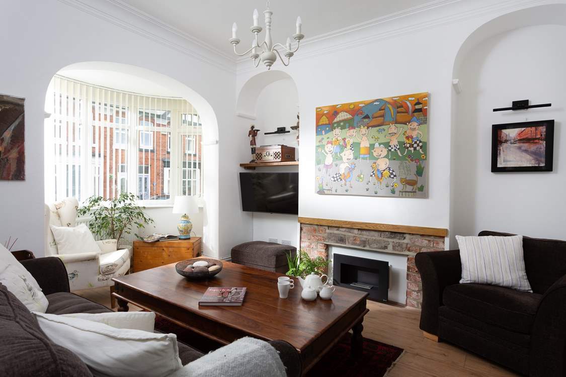 The cosy sitting-room has plenty of seating for everyone.