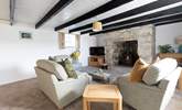 A warm and inviting sitting-room with plush cushions adding to the comfort. - Thumbnail Image