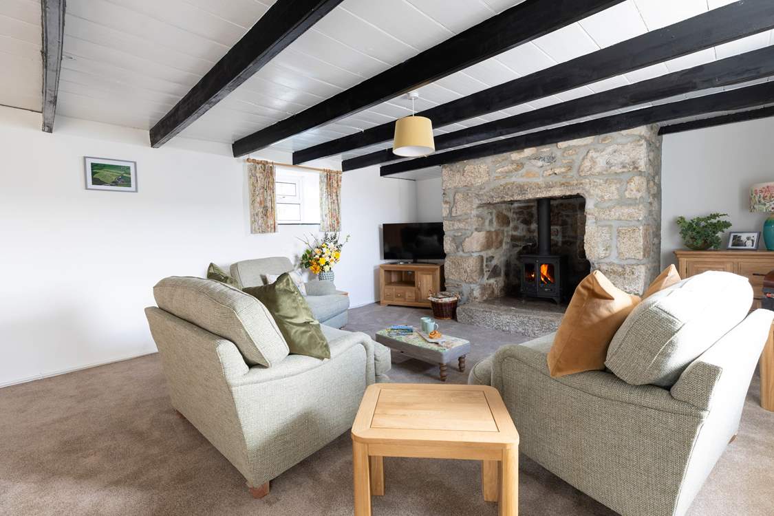 A warm and inviting sitting-room with plush cushions adding to the comfort.