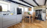 The cottage has a newly appointed kitchen with a sweet wood-burner. - Thumbnail Image