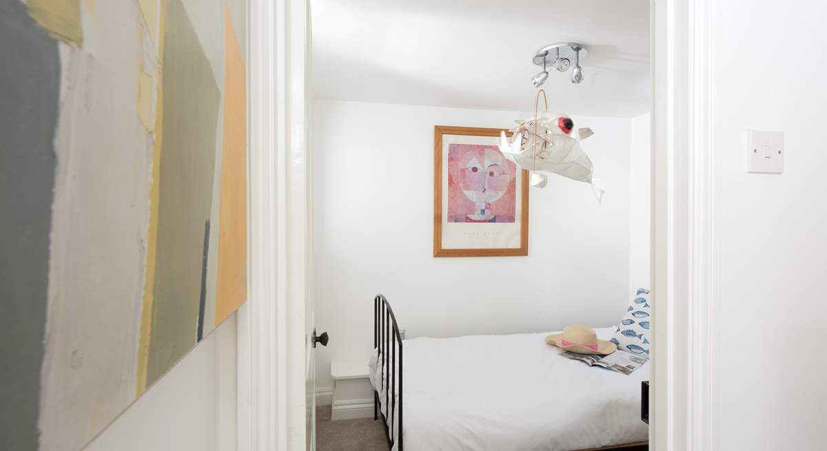 Down the stairs to the sweet single bedroom, tucked away.