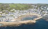 An aerial view of this small historic coastal village, with its sandy beach, bobbing fishing boats and many tales of smugglers gone by. - Thumbnail Image