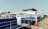 Step aboard your unique houseboat getaway. - Thumbnail Image