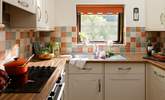 The kitchen looks out over another garden area. - Thumbnail Image