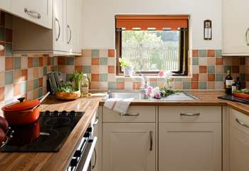 The kitchen looks out over another garden area.