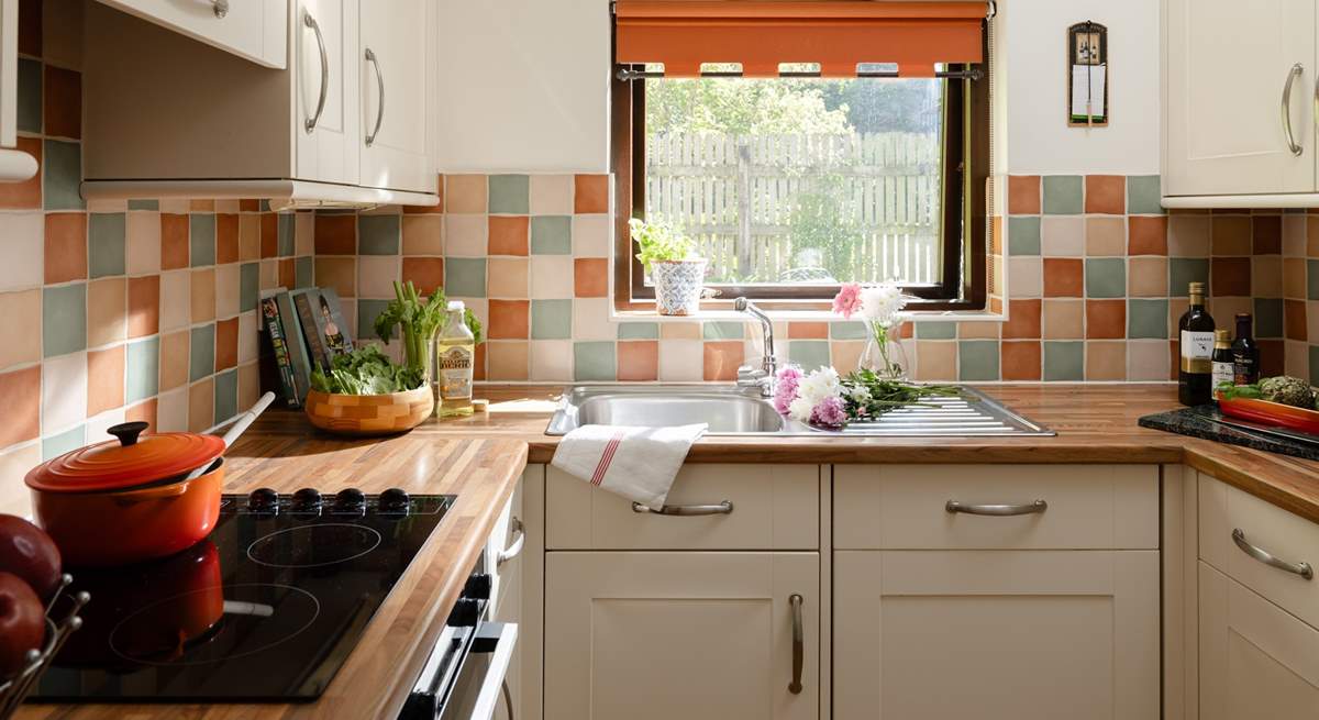 The kitchen looks out over another garden area.