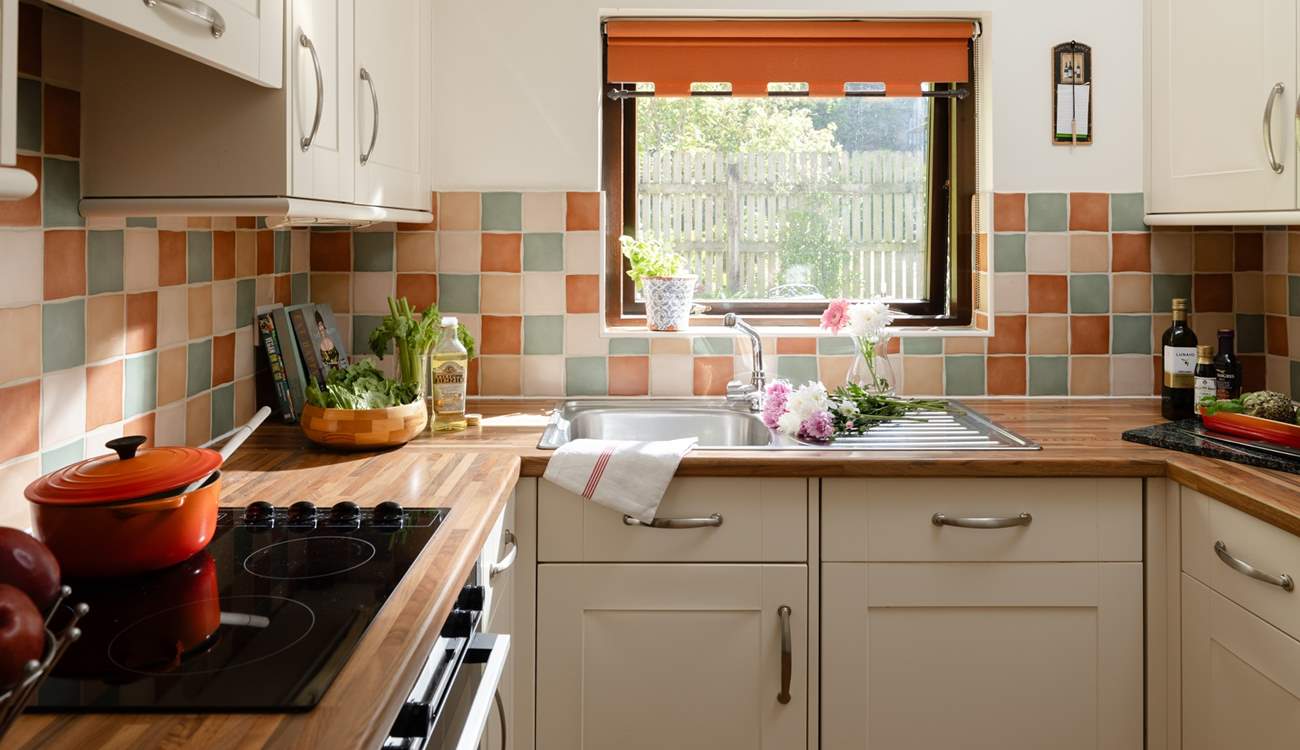 The kitchen looks out over another garden area.