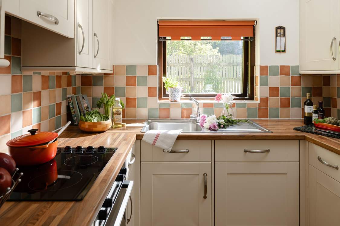 The kitchen looks out over another garden area.