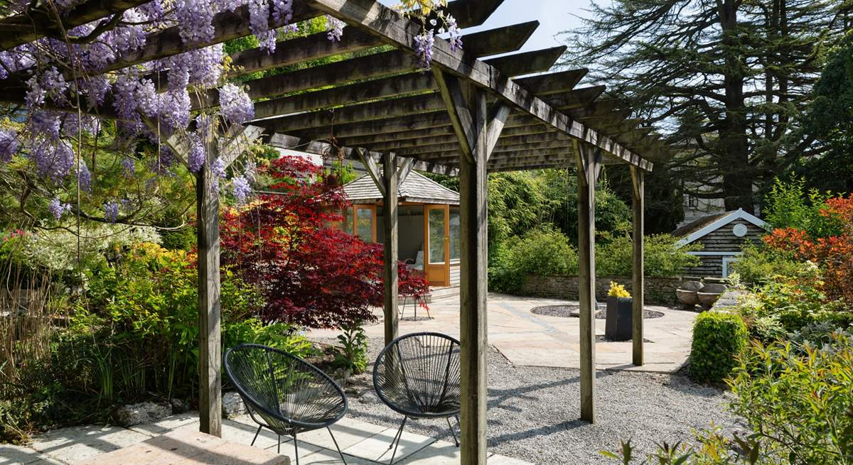 Sit in dappled shade under the pergola.