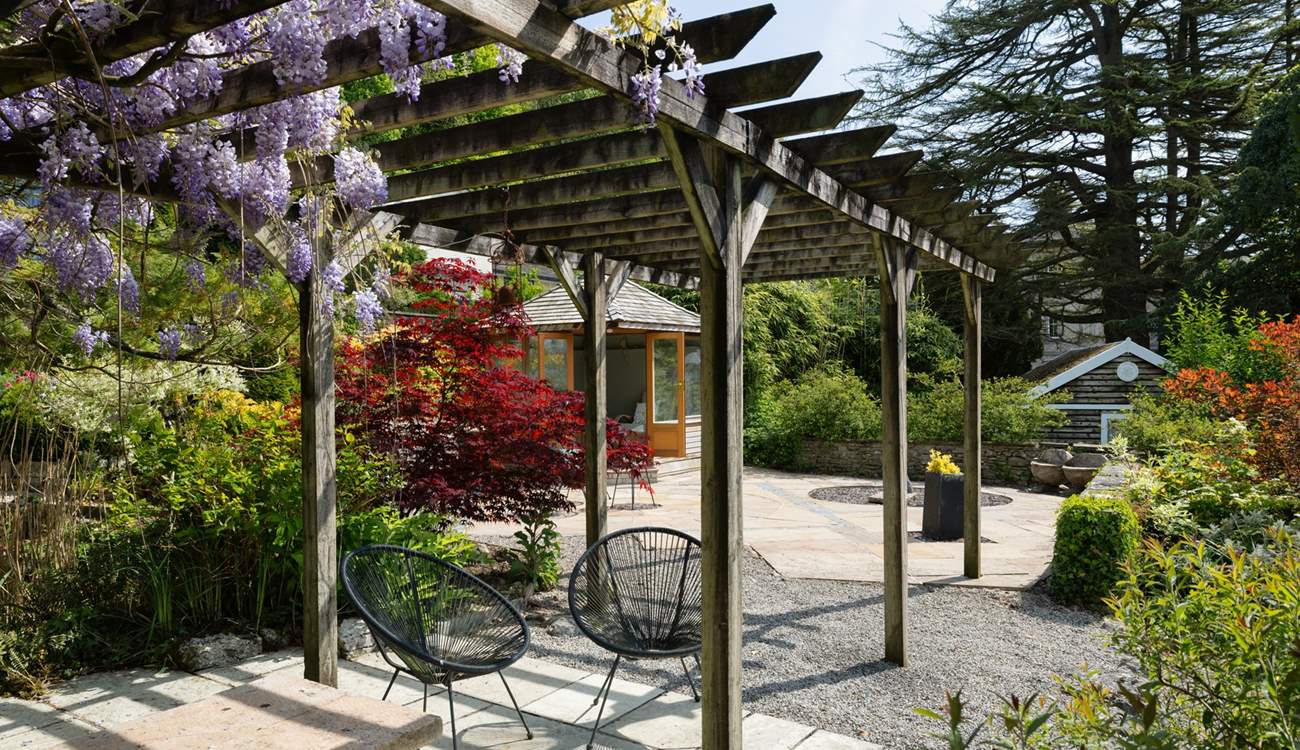 Sit in dappled shade under the pergola.