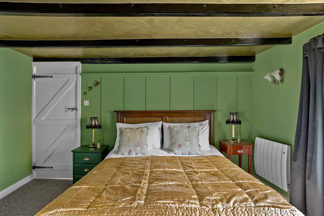 Snuggle under the covers of the king-size bed in bedroom 1.