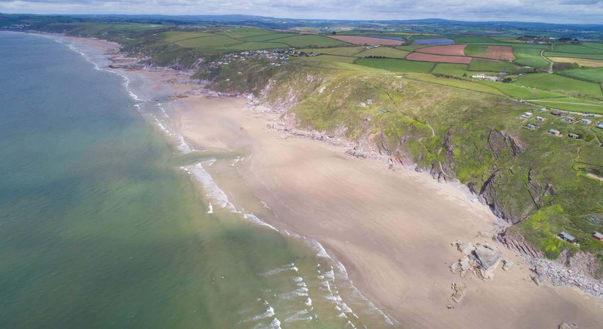 When the tide is out, the beach below stretches for miles and miles.